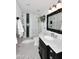 Elegant bathroom with glass shower, black and white tiles, marble countertop and vanity at 24024 N 74Th St, Scottsdale, AZ 85255