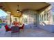 Covered patio with outdoor dining and ample seating overlooking the pool with ceiling fans at 24024 N 74Th St, Scottsdale, AZ 85255