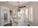 Breakfast nook with plantation shutters, chandelier, circular glass table, and upholstered chairs at 24024 N 74Th St, Scottsdale, AZ 85255