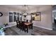 Formal dining room showcasing a rustic wood table, modern chandelier, and neutral decor at 24024 N 74Th St, Scottsdale, AZ 85255