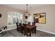 Warm dining area with wood table set, plantation shutters, and views into other living spaces at 24024 N 74Th St, Scottsdale, AZ 85255