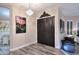 Elegant entryway featuring a decorative chandelier, a double door, and wood-look flooring at 24024 N 74Th St, Scottsdale, AZ 85255