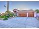 Charming single-story home featuring a three-car garage, desert landscaping, and well-maintained lawn at 24024 N 74Th St, Scottsdale, AZ 85255