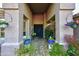 Inviting entrance with a stone pathway, blue potted plants, and double doors at 24024 N 74Th St, Scottsdale, AZ 85255