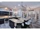 Well-lit kitchen with a large center island, granite countertops, stainless steel appliances, and modern lighting at 24024 N 74Th St, Scottsdale, AZ 85255