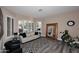 Bright living room with large windows, plantation shutters, neutral decor, and stylish wood-look floors at 24024 N 74Th St, Scottsdale, AZ 85255