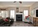 Bright living room featuring a fireplace, hardwood floors, and comfortable seating at 24024 N 74Th St, Scottsdale, AZ 85255