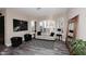 Bright living room with large windows, plantation shutters, neutral decor, and stylish wood-look floors at 24024 N 74Th St, Scottsdale, AZ 85255