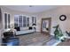 Bright living room featuring modern decor, wood-style flooring and large windows with plantation shutters at 24024 N 74Th St, Scottsdale, AZ 85255