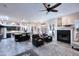 Open-concept living space with a fireplace, dark leather seating, and a kitchen with an island at 24024 N 74Th St, Scottsdale, AZ 85255