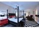 Spacious main bedroom suite with dark wood floors and a four-poster bed, offering a luxurious retreat at 24024 N 74Th St, Scottsdale, AZ 85255