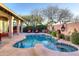 Inviting backyard pool and spa area with desert landscaping and comfortable seating at 24024 N 74Th St, Scottsdale, AZ 85255