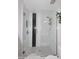 Modern walk-in shower featuring white marble, dark accents, and sleek glass enclosure at 24024 N 74Th St, Scottsdale, AZ 85255