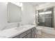 Modern bathroom with gray vanity, quartz countertop and subway tile shower at 28214 N 223Rd Ln, Wittmann, AZ 85361