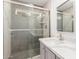 Contemporary bathroom features a glass-enclosed shower with herringbone tile and modern fixtures at 28214 N 223Rd Ln, Wittmann, AZ 85361