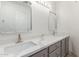 Elegant bathroom featuring double sinks, white countertops, and modern fixtures at 28214 N 223Rd Ln, Wittmann, AZ 85361