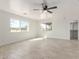 Spacious bedroom with wood-look tile flooring, a ceiling fan and bright natural light at 28214 N 223Rd Ln, Wittmann, AZ 85361