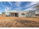 The exterior elevation of the single-story home showcasing its minimalist design and neutral color palette at 28214 N 223Rd Ln, Wittmann, AZ 85361