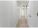 Hallway featuring hard surface flooring, neutral paint and ample closet space at 28214 N 223Rd Ln, Wittmann, AZ 85361