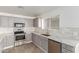 Stylish kitchen includes stainless steel appliances and gray cabinets with marble countertops at 28214 N 223Rd Ln, Wittmann, AZ 85361