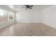 Bright living room features wood-look tile, fresh white walls and a ceiling fan at 28214 N 223Rd Ln, Wittmann, AZ 85361