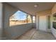 Covered porch with Southwestern architecture, stucco walls and a view of the desert landscape at 28214 N 223Rd Ln, Wittmann, AZ 85361