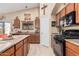 Well-equipped kitchen featuring stone countertops, dark appliances, and plenty of cabinet space at 29247 N Bauxite Ln, San Tan Valley, AZ 85143