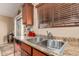 Close-up of the kitchen sink area featuring a stainless steel sink and granite countertops at 29247 N Bauxite Ln, San Tan Valley, AZ 85143