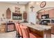 Open kitchen featuring a center island, granite countertops, and seating for three at 29247 N Bauxite Ln, San Tan Valley, AZ 85143