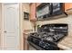 Kitchen corner with stainless steel gas range, over-the-range microwave, and granite countertops at 29247 N Bauxite Ln, San Tan Valley, AZ 85143