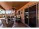 Cozy covered patio featuring a ceiling fan and elegant wicker furniture and sliding glass doors at 29247 N Bauxite Ln, San Tan Valley, AZ 85143