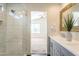 Bathroom featuring white tile shower, dual sink vanity, and decor at 3043 W Melinda Ln, Phoenix, AZ 85027