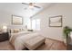 Bright bedroom features a ceiling fan, neutral walls, comfortable bed, and lots of natural light through the window at 3043 W Melinda Ln, Phoenix, AZ 85027