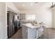 Bright kitchen featuring stainless steel appliances, granite countertops, and an island with seating for casual dining at 3043 W Melinda Ln, Phoenix, AZ 85027