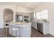 Bright open-concept kitchen featuring stainless steel appliances, granite countertops, and an island with bar stool seating at 3043 W Melinda Ln, Phoenix, AZ 85027