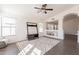 Open living area featuring a stylish media center, neutral paint, decorative ceiling fan, and easy flow to the kitchen at 3043 W Melinda Ln, Phoenix, AZ 85027