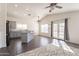 Bright, open concept kitchen with stainless steel appliances, granite countertops, and bar seating near the living area at 3043 W Melinda Ln, Phoenix, AZ 85027