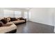 Comfortable living room featuring tile floors, natural light, stylish sectional sofa, and neutral paint at 3043 W Melinda Ln, Phoenix, AZ 85027