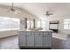 Bright open-concept living space featuring a kitchen island with seating and plenty of natural light from large windows at 3043 W Melinda Ln, Phoenix, AZ 85027