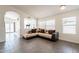 Inviting living room featuring vaulted ceilings, stylish sectional, tile floors, and seamless flow to the outdoor living at 3043 W Melinda Ln, Phoenix, AZ 85027