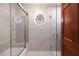 Elegant bathroom featuring a custom glass shower, tub and a decorative stained-glass window for a touch of sophistication at 3160 E Fox St, Mesa, AZ 85213