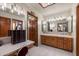 Bathroom featuring double sinks, vanity area and wooden cabinetry at 3160 E Fox St, Mesa, AZ 85213