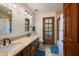 Bathroom with a double vanity, marble countertops, tiled floors and a tiled shower, offering a functional design at 3160 E Fox St, Mesa, AZ 85213