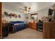 bedroom with carpeted floors, a ceiling fan, and decorated with toys and Star Wars collectibles at 3160 E Fox St, Mesa, AZ 85213