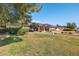 Well-manicured front yard with lush landscaping, enhancing the curb appeal of this charming residential property at 3160 E Fox St, Mesa, AZ 85213