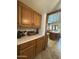 Oak cabinets and light countertops provide a bright and clean look in this charming kitchen at 3160 E Fox St, Mesa, AZ 85213