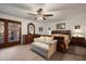 Bright main bedroom featuring a large window, a couch and classic furnishings at 3160 E Fox St, Mesa, AZ 85213