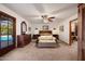 Serene main bedroom with a neutral palette, dark wood furniture, and access to the pool area at 3160 E Fox St, Mesa, AZ 85213