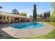 Inviting backyard pool with a large concrete patio perfect for outdoor activities and relaxing in the sun at 3160 E Fox St, Mesa, AZ 85213