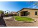 Expansive backyard featuring a manicured lawn, decorative gravel, and a gazebo frame, offering ample space for relaxation and recreation at 3233 N 137Th Dr, Avondale, AZ 85392